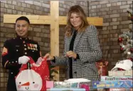  ?? ALASTAIR GRANT - ASSOCIATED PRESS ?? In this Dec. 4file photo, first lady Melania Trump joins local students and U.S. Marines stationed at the U.S. Embassy, wrapping holiday presents to be donated to the Salvation Army, at the Salvation Army Clapton Center in London.