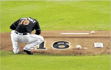  ?? PHOTOS BY ALLEN EYESTONE / THE PALM BEACH POST ?? Miami left-hander Adam Conley, who started in place of Jose Fernandez, takes a moment to collect his thoughts before throwing the fifirst pitch in Monday night’s game. All the Marlins wore Fernandez’s jersey number, which will be retired by the team.