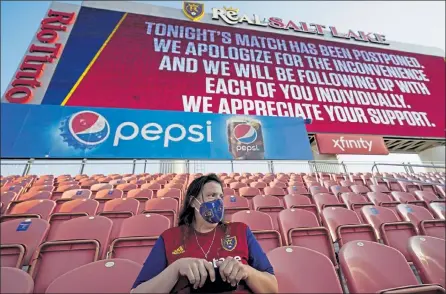  ?? AP ?? A fan sits in the stands after the scheduled game between Real Salt Lake and Los Angeles FC was postponed Wednesday, in Sandy, Utah. Major League Soccer players boycotted five games Wednesday night in a collective statement against racial injustice.