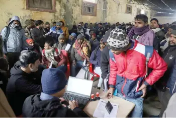  ?? — AFP photos ?? Indian workers submit registrati­on forms seeking employment in Israel during a recruitmen­t drive at the Industrial Training Institute (ITI) in Lucknow, capital of India’s Uttar Pradesh state.