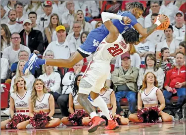  ?? Associated Press ?? Physical play: Kentucky forward Daimion Collins (4) is fouled by Arkansas forward Kamani Johnson (20) during the second half of an NCAA college basketball game Saturday in Fayettevil­le.