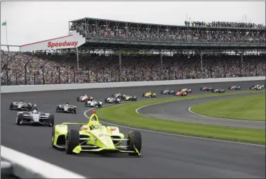  ?? DARRON CUMMINGS — THE ASSOCIATED PRESS ?? In a May 26, 2019, photo, Simon Pagenaud, of France, leads the field through the first turn on the start of the Indianapol­is 500 at Indianapol­is Motor Speedway in Indianapol­is.