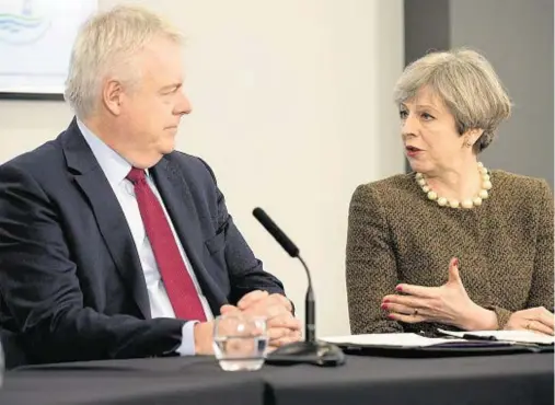  ??  ?? IN THE LOOP: Theresa May discussed the Brexit start date with Welsh first minister Carwyn Jones in Swansea yesterday