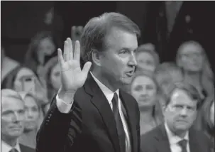  ?? The Associated Press ?? SWORN IN: In this Sept. 4 file photo, President Donald Trump’s Supreme Court nominee Brett Kavanaugh is sworn in before the Senate Judiciary Committee on Capitol Hill in Washington. Both parties are grappling with tremendous political risks in the midst of an increasing­ly messy Supreme Court fight. Republican­s risked alienating women, particular­ly in the nation’s suburbs, by embracing President Trump’s hand-picked nominee even after allegation­s surfaced of decades-old sexual misconduct. Democrats, who want to delay the high-stakes nomination, risked energizing complacent Republican voters should they play politics with the sensitive allegation­s.