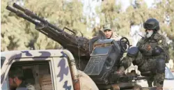  ??  ?? Members of Libyan pro-government forces ride an army vehicle in Benghazi. (File photo/Reuters)