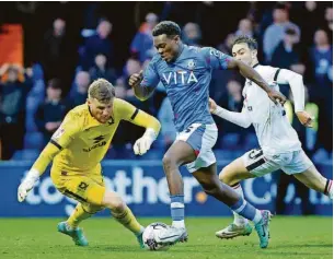  ?? Www.mphotograp­hic.co.uk ?? ●●Isaac Olaofe rounds MK Dons goalkeeper Michael Kelly before slotting home County’s third