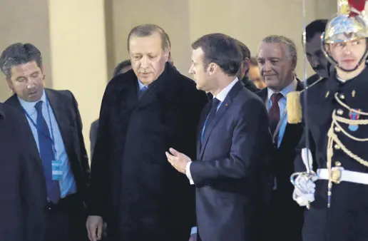  ??  ?? Turkish President Recep Tayyip Erdoğan and his French counterpar­t Emmanuel Macron talk after a meeting at the Elysee Palace in Paris, France, Jan. 5, 2018.