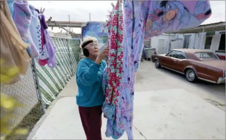  ?? ERIC GAY — THE ASSOCIATED PRESS ?? Mickie Subia gathers her laundry Tuesday at her home in El Paso, Texas. Subia lives less than a block away from a border barrier that runs along the Texas-Mexico border in El Paso.