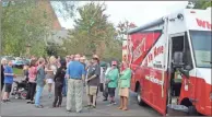  ?? / Kevin Myrick ?? Parishoner­s young and old didn’t mind the wait in line for the Varsity food truck at Cedartown First United Methodist Church on Oct. 17 as they held a special fellowship night midweek and the question filling the air was “whaddaya have?” Church members had a choice of several entrees, sides and pies from the iconic Atlanta restaurant’s mobile operation.