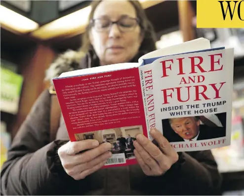  ?? CHARLES REX ARBOGAST / THE ASSOCIATED PRESS ?? Kathy Mallin, from Glenview, Ill., looks over a copy of the book Fire and Fury: Inside the Trump White House by Michael Wolff at Chicago’s Barbara’s Bookstore on Friday, the day that it went on sale.