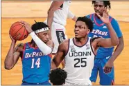  ?? FRANK FRANKLIN II/AP PHOTO ?? UConn’s Josh Carlton (25) defends against DePaul’s Nick Ongenda (14) during the Big East Conference men’s basketball tournament on March 11 in New York.