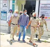  ??  ?? Sohail Singh Brar being taken away after his appearance in a Faridkot court on Wednesday. Formerly a witness in the case, he allegedly helped the accused cops make fabricated bullet marks on an escort vehicle of the then Moga SSP. HT PHOTO