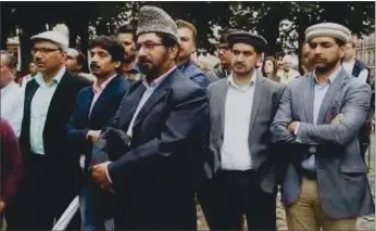  ??  ?? Muslims gather outside the Cathedral in Rouen, France during the funeral service in memory of slain priest Jacques Hamel