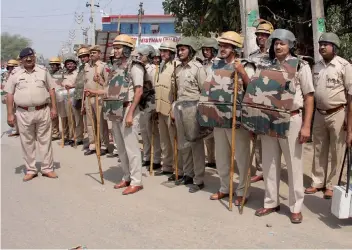  ?? — PTI ?? Police personnel are deployed at various sensitive places in view of the Jat agitation for reservatio­n in Gurgaon on Monday.