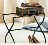  ??  ?? Keep luggage off the guest room floor with a luggage rack. Light and easy to store, this Gaspar rack is from Ballard Designs and many homeowners use a couple of these at the foot of their bed for pillows.