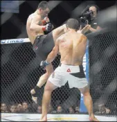  ?? ERIK VERDUZCO/REVIEW-JOURNAL ?? Dominick Cruz, left, jumps to deliver a kick against Urijah Faber in their UFC 199 bantamweig­ht title bout at The Forum in Inglewood, Calif., on Saturday night. Cruz won by unanimous decision.