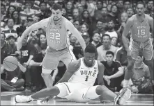  ?? ROB KINNAN / USA TODAY SPORTS ?? Duke Blue Devils forward Zion Williamson reacts after his left shoe blew out during a fall while driving to the basket against North Carolina Tar Heels forward Luke Maye in Durham, North Carolina, on Wednesday.