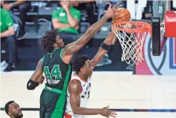  ?? AP ?? The Celtics’ Robert Williams III (44) fouls the Raptors’ OG Anunoby during the first half on Sunday.