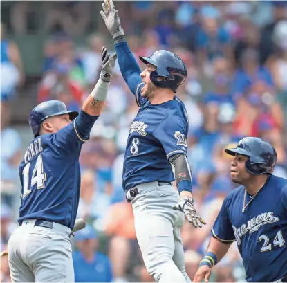  ?? PATRICK GORSKI / USA TODAY SPORTS ?? Ryan Braun (center) celebrates his two-run home run during the first inning.