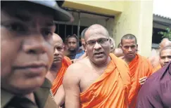  ??  ?? The Sri Lankan Buddhist monk Galagodaat­te Gnanasara, shown here surrenderi­ng in response to an arrest warrant last June, is out on bail while facing hate speech charges.