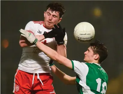  ??  ?? Tyrone’s Rory Brennan battles for possession with Conor McHugh of Fermanagh on Wednesday night when defensive play dominated the action, which some believe is down to the limit placed on the handpass in the experiment­al rules