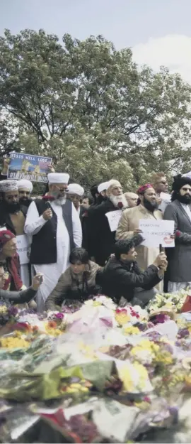  ??  ?? 0 Imams and local Muslims yesterday laid flowers near the scene of