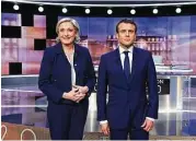  ?? Eric Feferberg / Associated Press ?? French presidenti­al election candidates, Marine Le Pen, left, and Emmanuel Macron pose prior to the start of a live broadcast televised debate Wednesday.