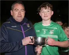  ??  ?? Evan Harper receiving the cup from P.J. Howlin, Co. P.R.O.