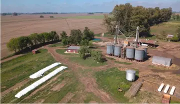  ?? — AFP photo ?? Aerial view of silo bags and traditiona­l silos at a farm in San Antonio de Areco, Buenos Aires province, Argentina. Argentina is one of the world main producers of cereals, oleaginous and agroindust­rial products, and the number one exporter of flour and soy oil.