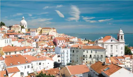  ?? CAMERON HEWITT ?? Breathtaki­ng views are bountiful in Miradouro Santa Luzia, a city of red-tiled roofs on the yawning mouth of the Tejo River.