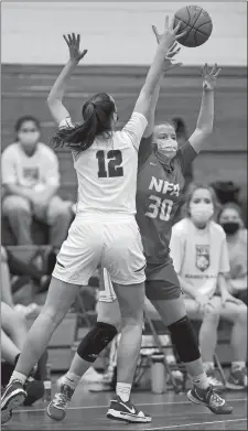  ?? SEAN D. ELLIOT/THE DAY ?? NFA forward Cailtin Daley passes the ball away from the pressure by Waterford guard Lily Kramer (12) during Wednesday’s ECC South game in Waterford. The No. 1 Wildcats rolled to a 54-23 win.