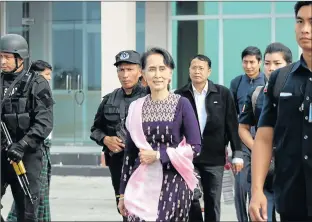  ?? Picture: AFP ?? SHUTTLE DIPLOMACY: Myanmar leader Aung San Suu Kyi, centre, arrives at Sittwe airport for an unannounce­d visit to the restive Rakhine state yesterday