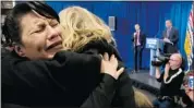  ?? Jonathan Hayward/canadian Press ?? Cee Jai Julian, left, cries as Commission­er Wally Oppal, background, delivers his final report on the Missing Women Commission in Vancouver on Monday.