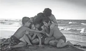 ?? CARLOS SOMONTE ?? Cleo (Yalitza Aparicio, center) is embraced by the children she cares for in the tear-jerking climax of Alfonso Cuaron’s “Roma.”