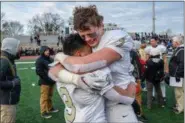  ?? MARK PALCZEWSKI - FOR DIGITAL FIRST MEDIA ?? Luke Painton (7) and Luis Garcia (3) of Berks Catholic hug after the District 3 Class 4A championsh­ip game in Lancaster on Friday, November 23.