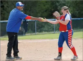  ?? Photo by Becky Polaski ?? Lady Dutch head coach Matt Eckels presents senior pitcher Kendall Young with the ball she used to record her 500th career strikeout in the top of the third inning of Wednesday’s game against DCC.