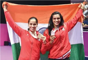  ?? PTI file ?? Saina Nehwal and Sindhu pose with their medals at the Commonweal­th Games. —