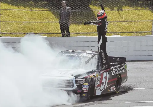  ?? AP PHOTO ?? SMOKIN’: Kyle Busch celebrates after winning the NASCAR Truck Series race yesterday at Pocono Raceway in Long Pond, Pa.