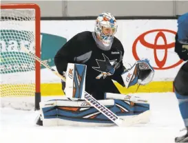  ?? JIM GENSHEIMER/STAFF ?? After Monday’s roster cuts Aaron Dell, here defending against a shot in practice recently, and starter Martin Jones are the only goalies remaining on the Sharks’ active roster.