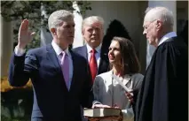  ?? Photo: AP ?? Donald Trump watches as Supreme Court Justice Anthony Kennedy administer­s the judicial oath to Justice Neil Gorsuch at the White House. Holding the Bible is Gorsuch’s wife Marie Louise Gorsuch.