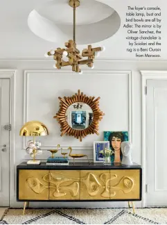  ??  ?? The foyer’s console, table lamp, bust and bird bowls are all by Adler. The mirror is by Oliver Sanchez, the vintage chandelier is by Sciolari and the rug is a Beni Ourain
from Morocco.