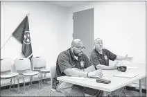  ??  ?? Detective Zachery Gatlin, right, talks about a case he worked during a weekly Project Safe Neighborho­ods meeting to review cases where guns, ammunition or shell casings are recovered.