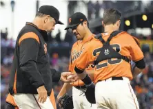  ?? Ben Margot / Associated Press ?? Giants manager Bruce Bochy takes the ball from Matt Moore after his starting pitcher was strafed for 12 hits in 31⁄3 innings.