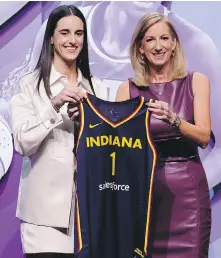  ?? ADAM HUNGER, THE ASSOCIATED PRESS ?? University of Iowa guard Caitlin Clark, left, poses with WNBA commission­er Cathy Engelbert after being selected first overall by the Indiana Fever during the WNBA draft Monday in New York.