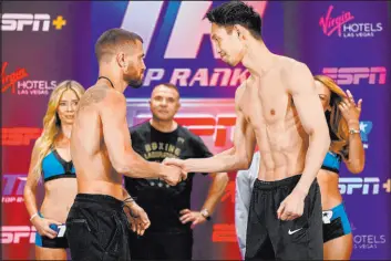  ?? John Locher The Associated Press ?? Ukraine’s Vasiliy Lomachenko, left, and Japan’s Masayoshi Nakatani face off Saturday in the main event of a Top Rank card at Virgin Hotels Las Vegas.