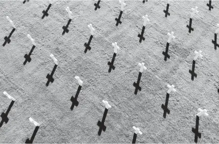  ?? David Vincent / Associated Press ?? In the American Normandy cemetery of Colleville-sur-Mer, where 9,387 fallen U.S. service members are buried, rows of white crosses are a strong reminder of the sacrifices made by some 156,000 Allied troops.