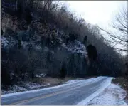  ?? Spencer Lahr / RN-T ?? Snow covers portions of the cliffs off Black’s Bluff Road while some ice remains on the pavement Wednesday.