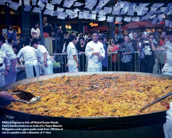  ??  ?? PAELLA Gigante to kick off Madrid Fusion Manila. Chef J Gamboa looks on as chefs of Le Toque Blanche Philippine­s cook a giant paella made from 100 kilos of rice in a paellera with a diameter of 11 feet.