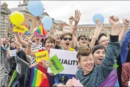  ?? CHARLES MCQUILLAN / GETTY IMAGES ?? Thousands of people celebrate in Dublin Castle Square as the result of the referendum is relayed in Dublin, Ireland. Ireland is the first country to approve gay marriage in a popular national vote.