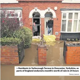  ?? Danny Lawson ?? > Residents in Yarborough Terrace in Doncaster, Yorkshire, as parts of England endured a month’s worth of rain in 24 hours